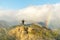 Young male hiker standing on the summit of Diamond Head Crater in Honolulu on the Island of Oahu, Hawaii shortly before sunset