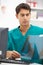 Young male hospital doctor at desk