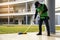 Young Male Janitor Cleaning Floor With Mopping  on modern building