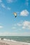 Young male kiteboarding along a tropical beach