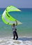 Young male kitesurfer holding kite steady