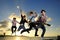 Young male musicians jumping with instruments