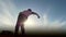 Young male parkour tricker jumper performs amazing flips in front of the sun