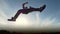 Young male Parkour tricker jumper performs amazing flips, silhouette
