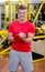 Young male personal trainer writing on clipboard smiling