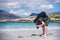 Young male photographer with dreadlocks at a sunny white sand beach, Luskentyre, Isle of Harris, Hebrides, Scotland