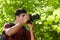 Young male photographer hiking in forest