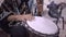 A young male playing djembe drums in a mexican jam session wearing a poncho