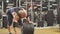 Young male powerlifter preparing for deadlift of barbell during competition, spending time in gym