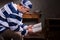 Young male prisoner wearing prison uniform reading a book or a b