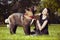 Young male puppy of American Akita dog relaxing with his owner lady