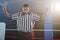 Young male referee gesturing while looking down in boxing ring