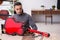 Young male repairman repairing guitar