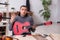 Young male repairman repairing guitar