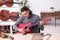 Young male repairman repairing guitar