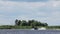 Young male is riding on waterski on water surface following boat along river