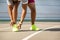 Young male runner bending over an untied shoelace