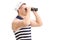 Young male sailor looking through binoculars