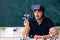 Young male scientist sitting in the classroom