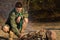 Young Male Scout Grilling Sausages at the Camp