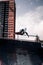 Young male skater performing a skateboarding trick as he ascends up the side of a sloped ramp