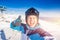 Young male skier smiling makes selfie photo on background of winter ski resort in protective helmet, sunny day