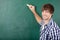 Young Male Student Writing On Chalkboard