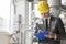 Young male supervisor writing on clipboard in industry