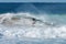 Young male surfer locked in the tube of wave