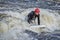 Young male is surfing a wave in the Poudre River Whitewater Park