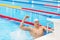 Young male swimmer celebrating victory in the swimming pool