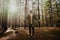 Young male taking in the surroundings of the forest, deep breaths and religious connection with nature