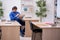 Young male teacher checking notes in the classroom