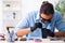 Young male technician repairing mobile phone