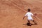 Young male tennis player with racket in action. Boy plays tennis on tennis court. Child is focused on game. Copy space