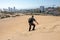 Young male traveler sandboarding at Concon sand dune in Vina del Mar, Chile