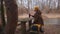 Young male traveller sitting by the riverside drinking tea and relaxing admiring