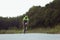 Young male triathlete riding a bicycle on the open road. Professional sportsman is engaged in triathlon on bright summer