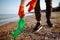 Young male volunteer picks up plastic garbage on the ocean coast. A man collects waste on the seaside to save ecology and protect