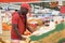 Young male worker of modern supermarket carrying wooden box with apples