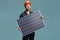 Young male worker in a unifrom holding a solar cell photovoltaic module