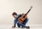 Young man with acoustic guitar composing song