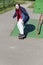 A young man is actively skateboarding alone on the street