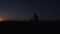 A young man is actively spending time on his bike at sunset