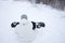 Young man adjusting his snowboard in the snow