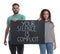 Young man and African American woman holding sign with phrase Your Silence Is Complicit on white background. Racism concept