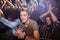 Young man amidst crowd enjoying at nightclub