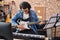 Young man artist playing electrical guitar at music studio