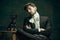 Young man as Dorian Gray on dark background. Retro style, comparison of eras concept.