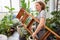 Young man as a gardener or florist with ladder